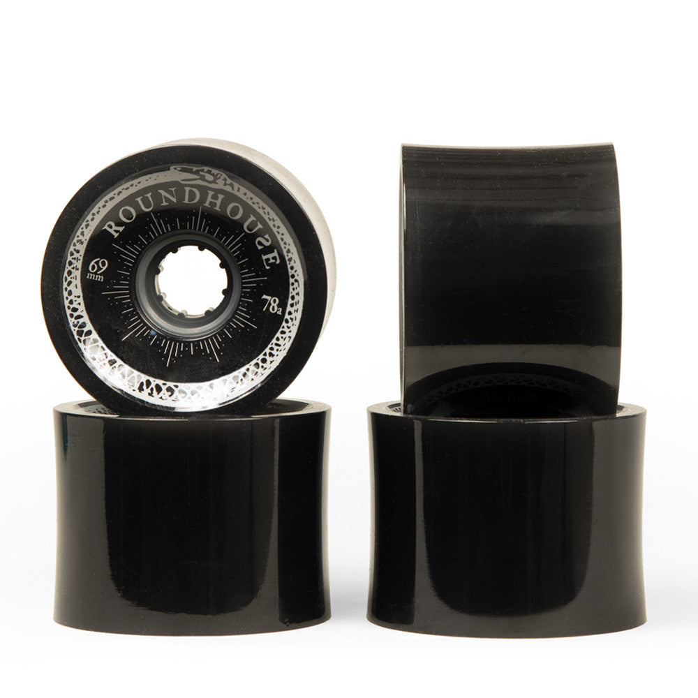 Four black Carver Roundhouse 69mm 78A concave surfskate wheels with white branding.