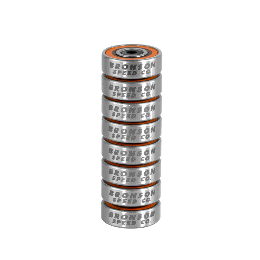 Stack of eight silver Bronson Speed Co. G3 skateboard bearings with orange shields.