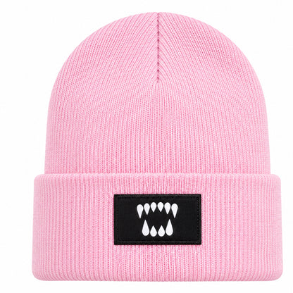 Pink cuffed knit beanie with embroidered Dawn Fang logo patch by Blak Bear Surf Club.