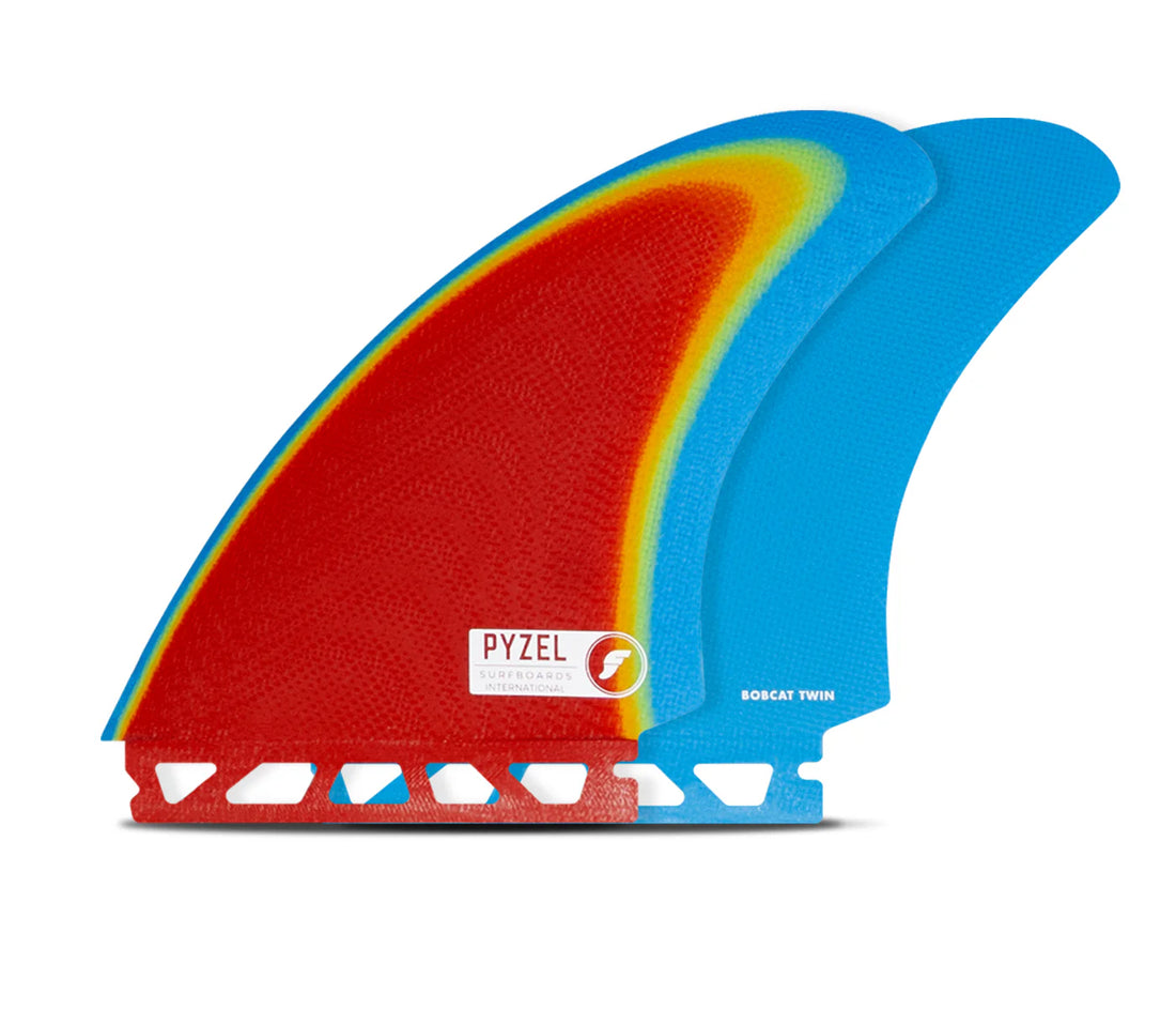Two surfboard fins, one red and yellow, one blue, with a Pyzel logo on a white background.