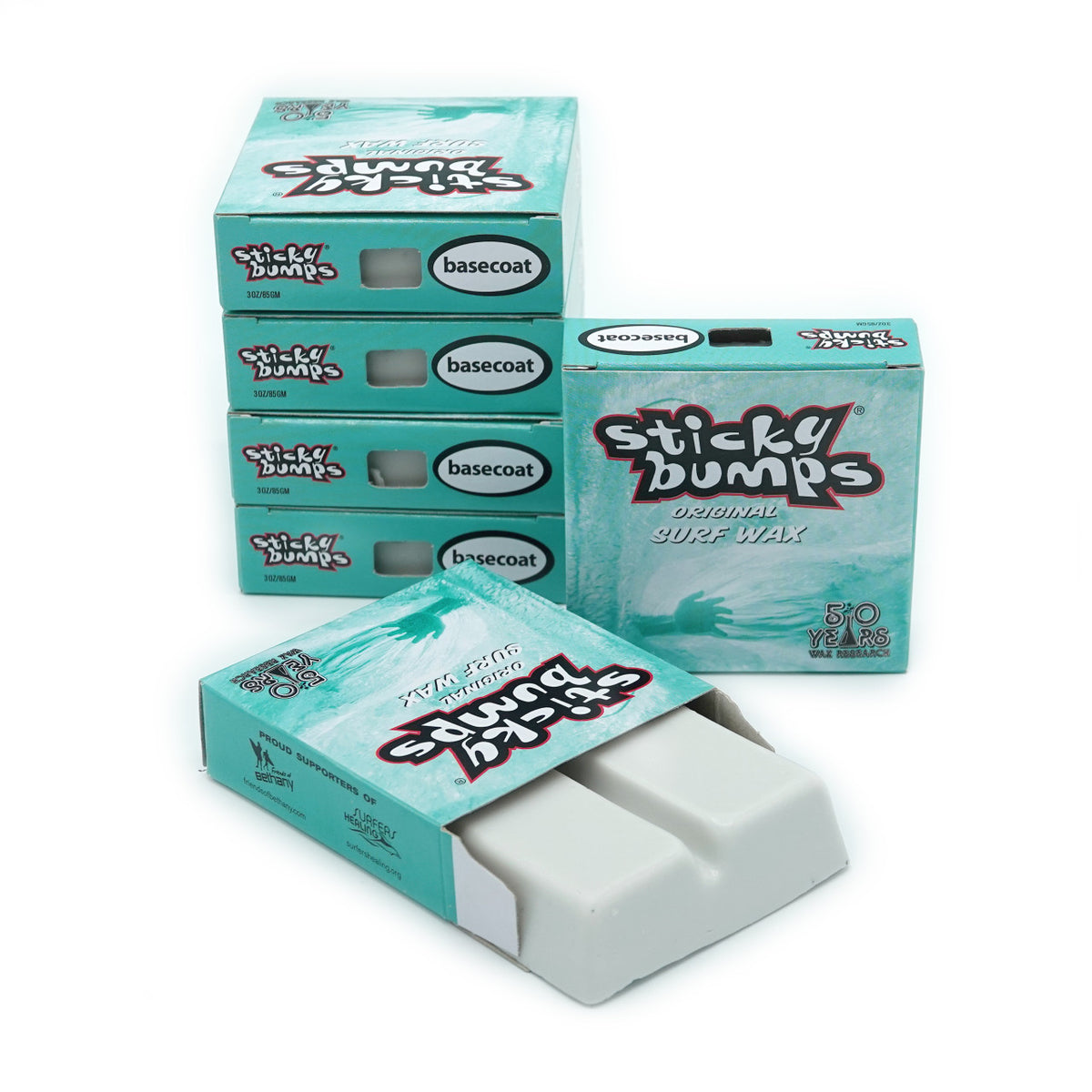 Stack of Sticky Bumps Original Basecoat Surf Wax boxes, light blue with white and red branding, one open showing white wax bars.